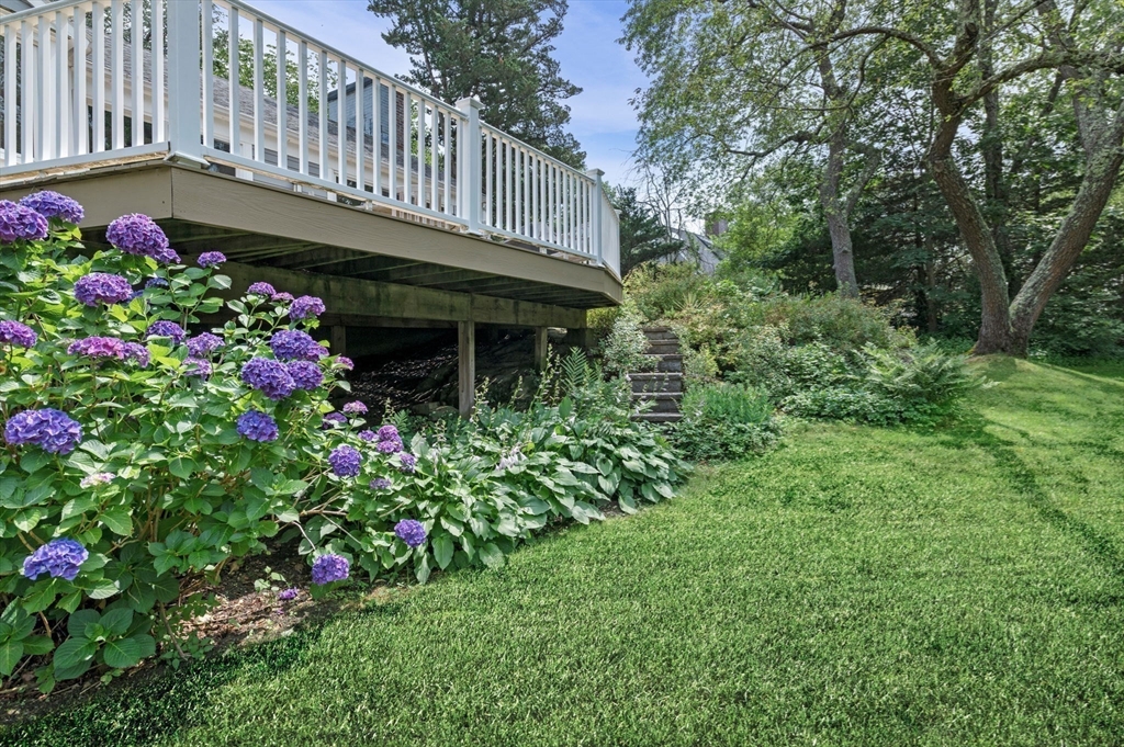 7 Ratlin Road Marblehead, MA 01945 - Photo 3 of 23 a garden with flowers and wooden fence