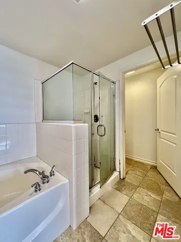 a bathroom with a bathtub and a shower