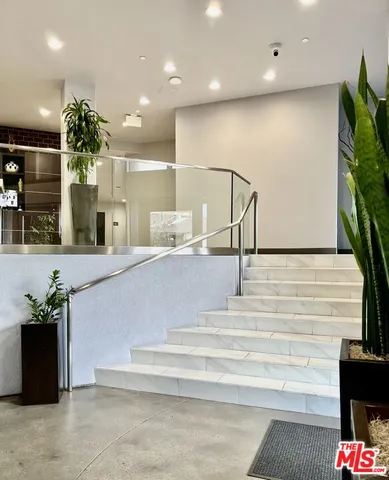 a view of a kitchen with furniture and a potted plant