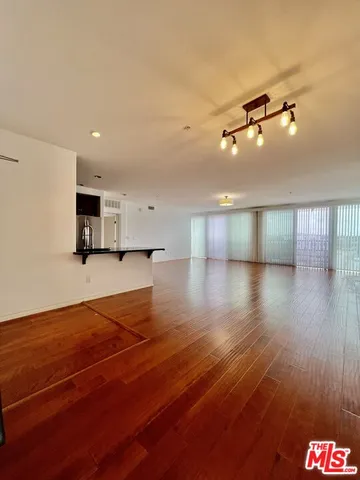 a view of a room with wooden floor and staircase