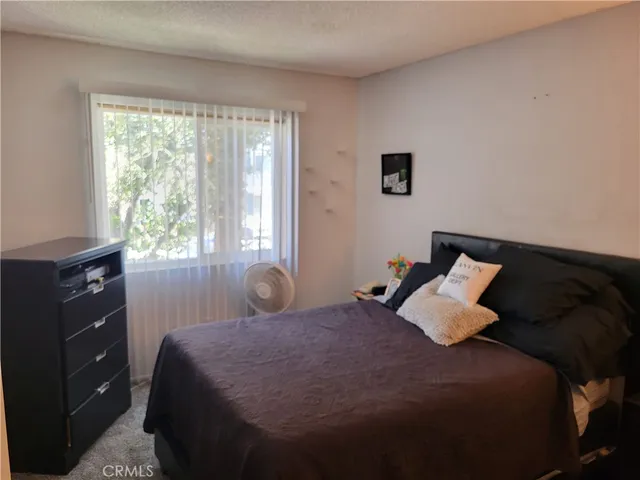 a bedroom with a bed and window