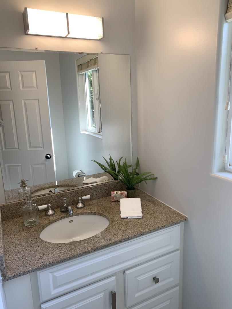 230 Springer Road Los Altos, CA 94024 - Photo 12 of 28 a bathroom with a granite countertop sink and a mirror