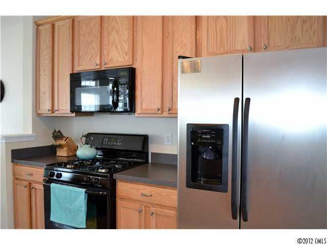 190 Snead Road, Unit 190 Fort Mill, SC 29715 - Photo 4 of 16 a kitchen with stainless steel appliances granite countertop a refrigerator and a stove top oven