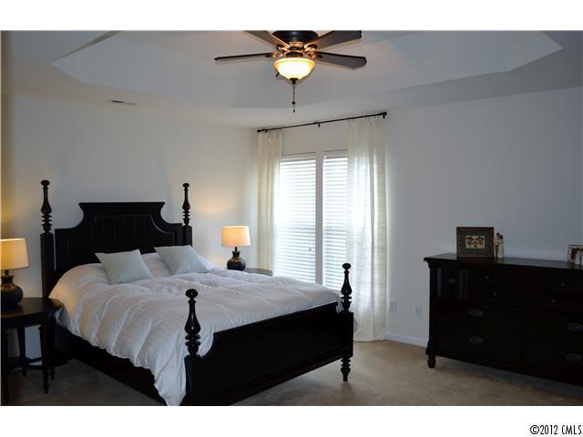 190 Snead Road, Unit 190 Fort Mill, SC 29715 - Photo 9 of 16 a bedroom with a bed and a chandelier