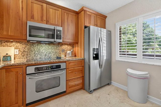 a kitchen with a refrigerator stove and microwave