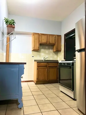 a kitchen with a sink a stove top oven a counter space and cabinets