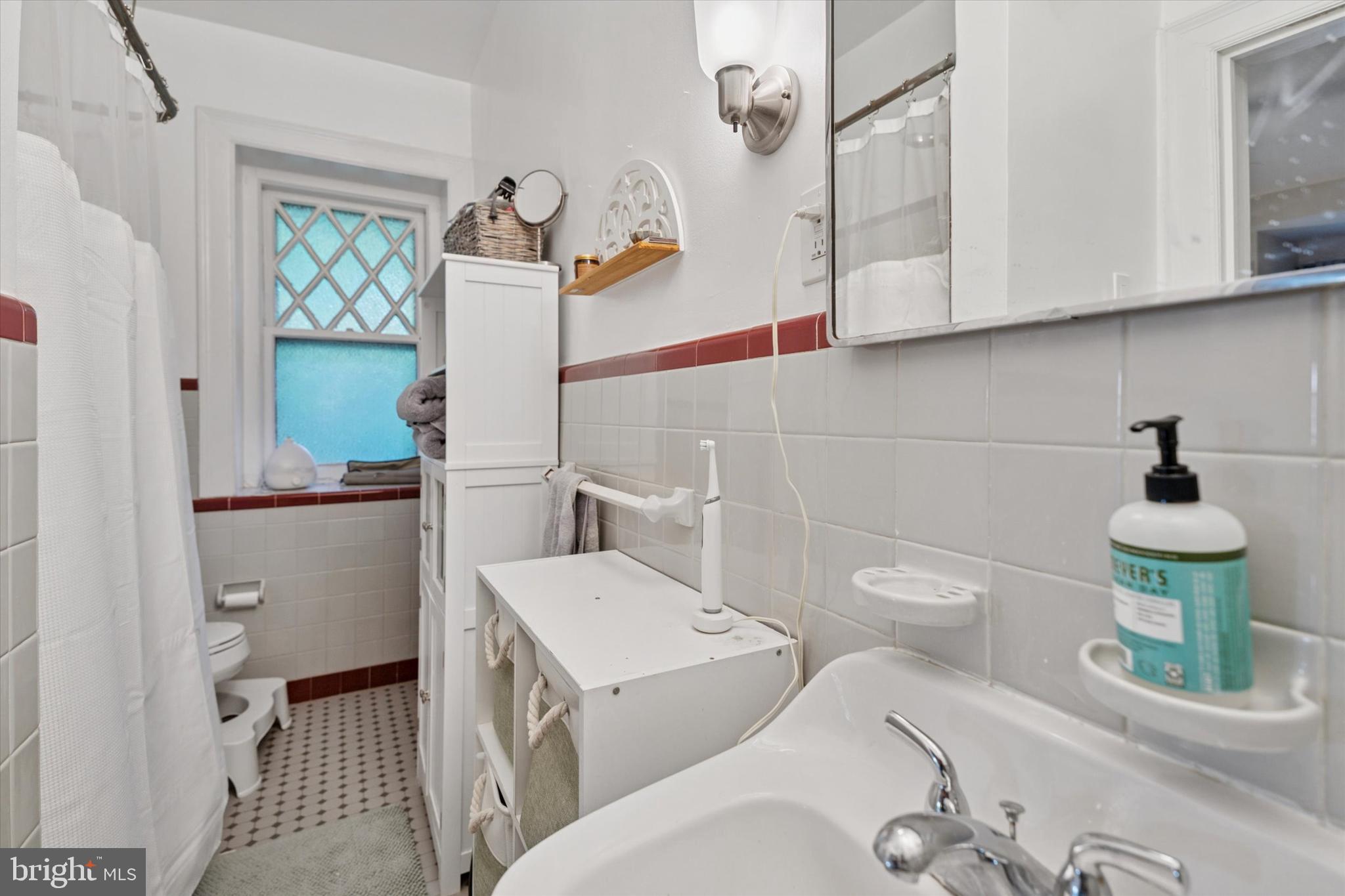 2814 Midvale Avenue Philadelphia, PA 19129 - Photo 13 of 25 a bathroom with a sink a toilet and mirror