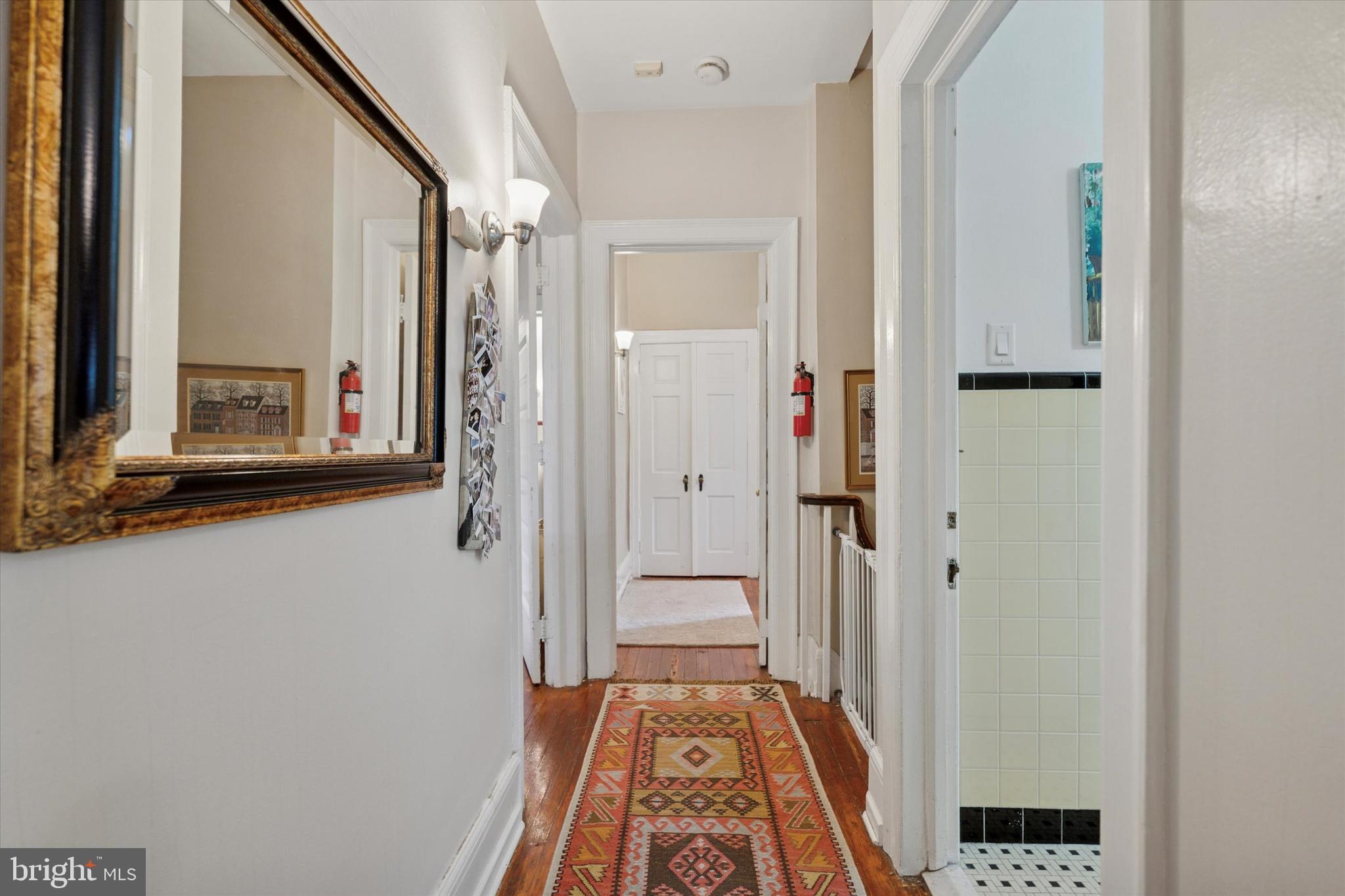 2814 Midvale Avenue Philadelphia, PA 19129 - Photo 20 of 25 a view of a hallway with wooden floor and a bathroom
