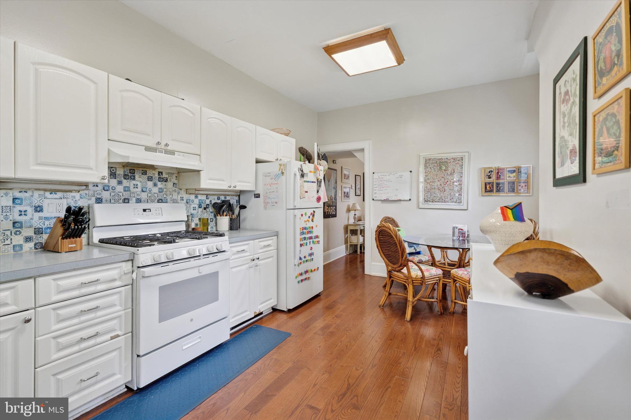 2814 Midvale Avenue Philadelphia, PA 19129 - Photo 5 of 25 a kitchen with stainless steel appliances a stove a sink a dining table and chairs