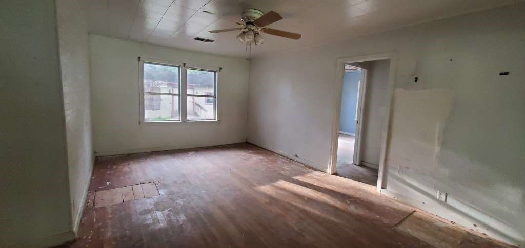 6136 25th Street Groves, TX 77619 - Photo 5 of 20 a view of a livingroom with a staircase