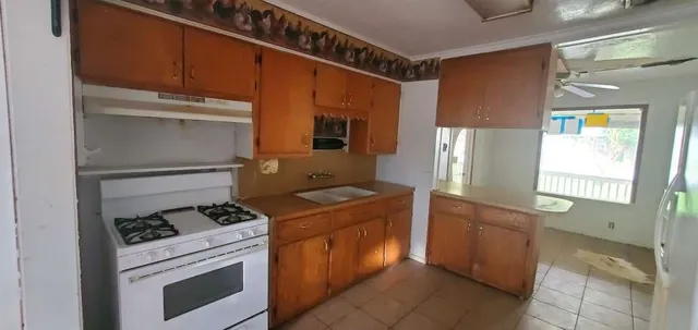a kitchen with a stove and a refrigerator