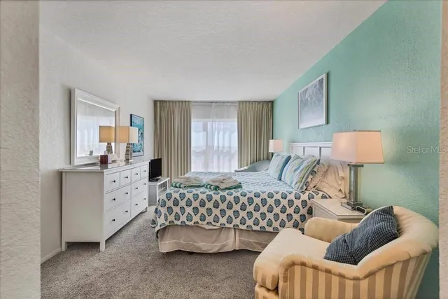 a bedroom with furniture and a window