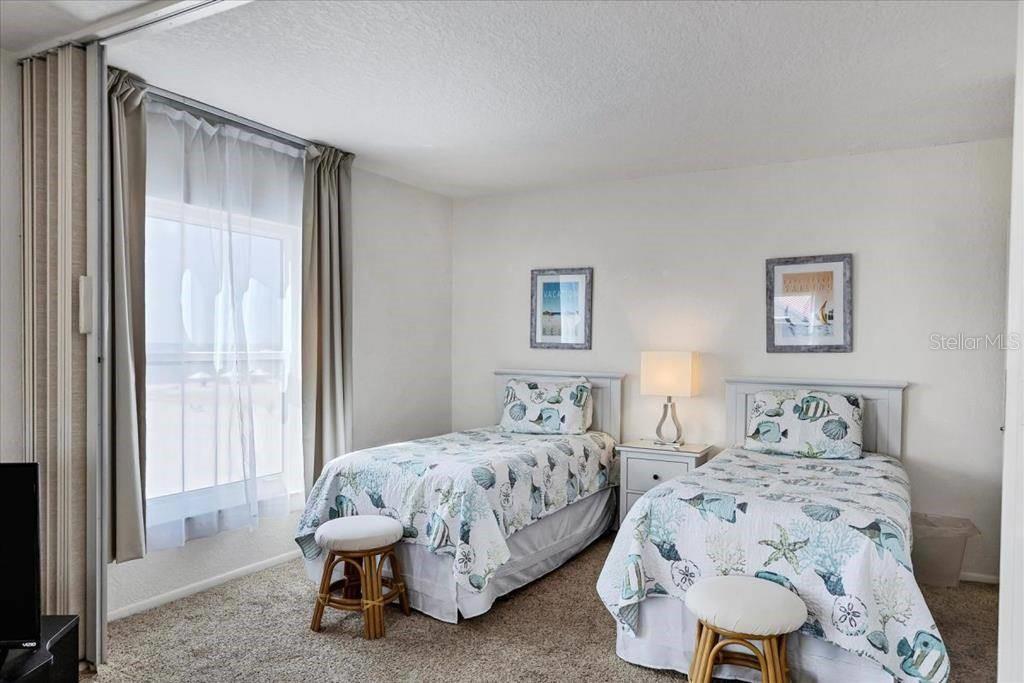 6154 Midnight Pass Road, Unit 301 Sarasota, FL 34242 - Photo 9 of 12 a bedroom with a bed and a window