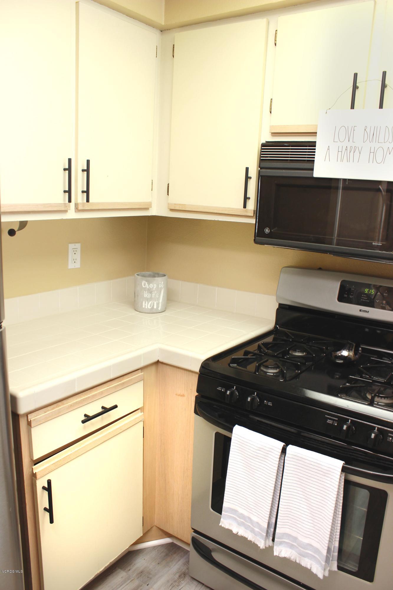 4240 Lost Hills Road, Unit 2907 Calabasas, CA 91301 - Photo 12 of 31 a kitchen with a stove and a microwave