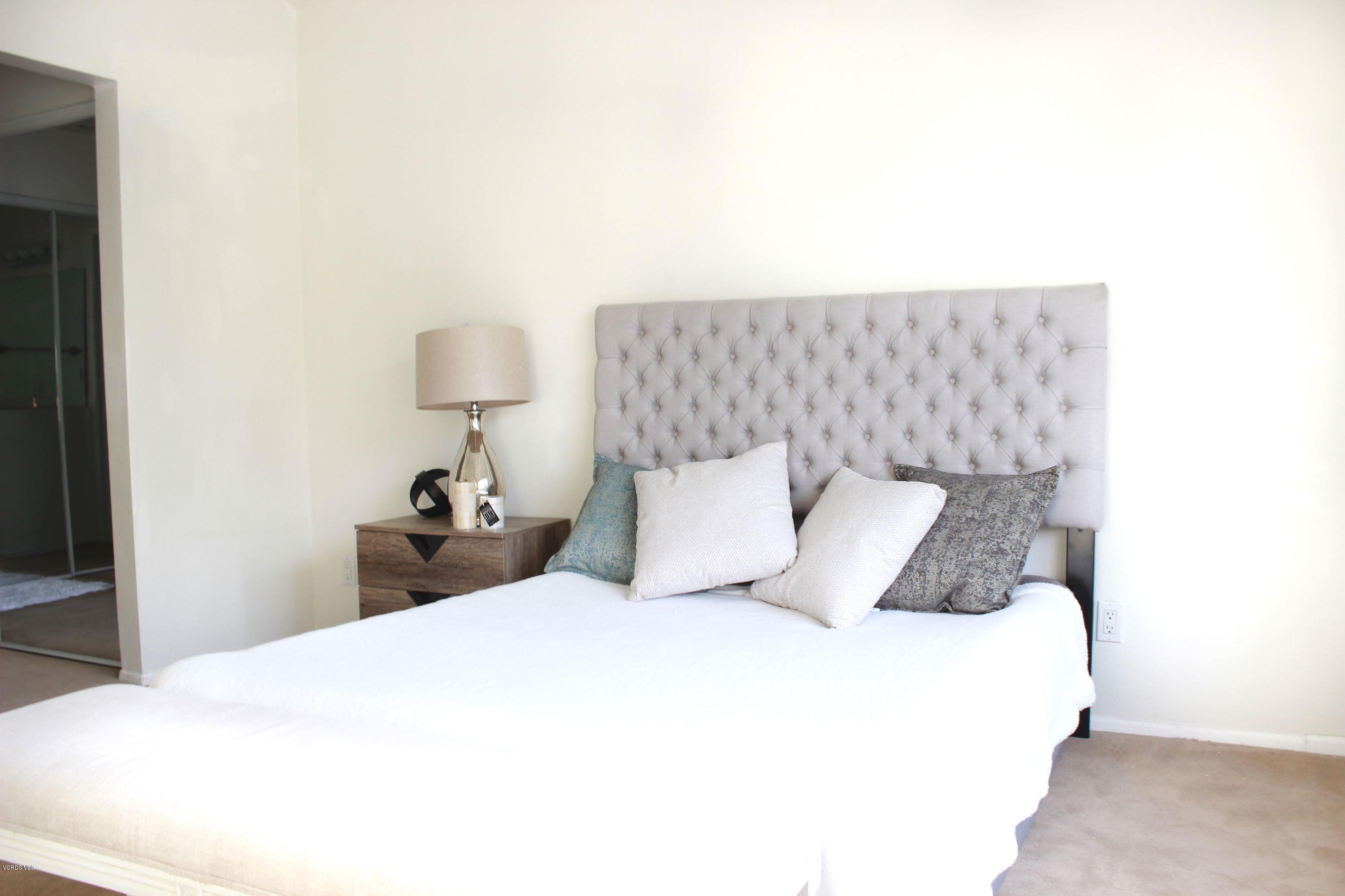 4240 Lost Hills Road, Unit 2907 Calabasas, CA 91301 - Photo 15 of 31 a bedroom with a bed and a lamp