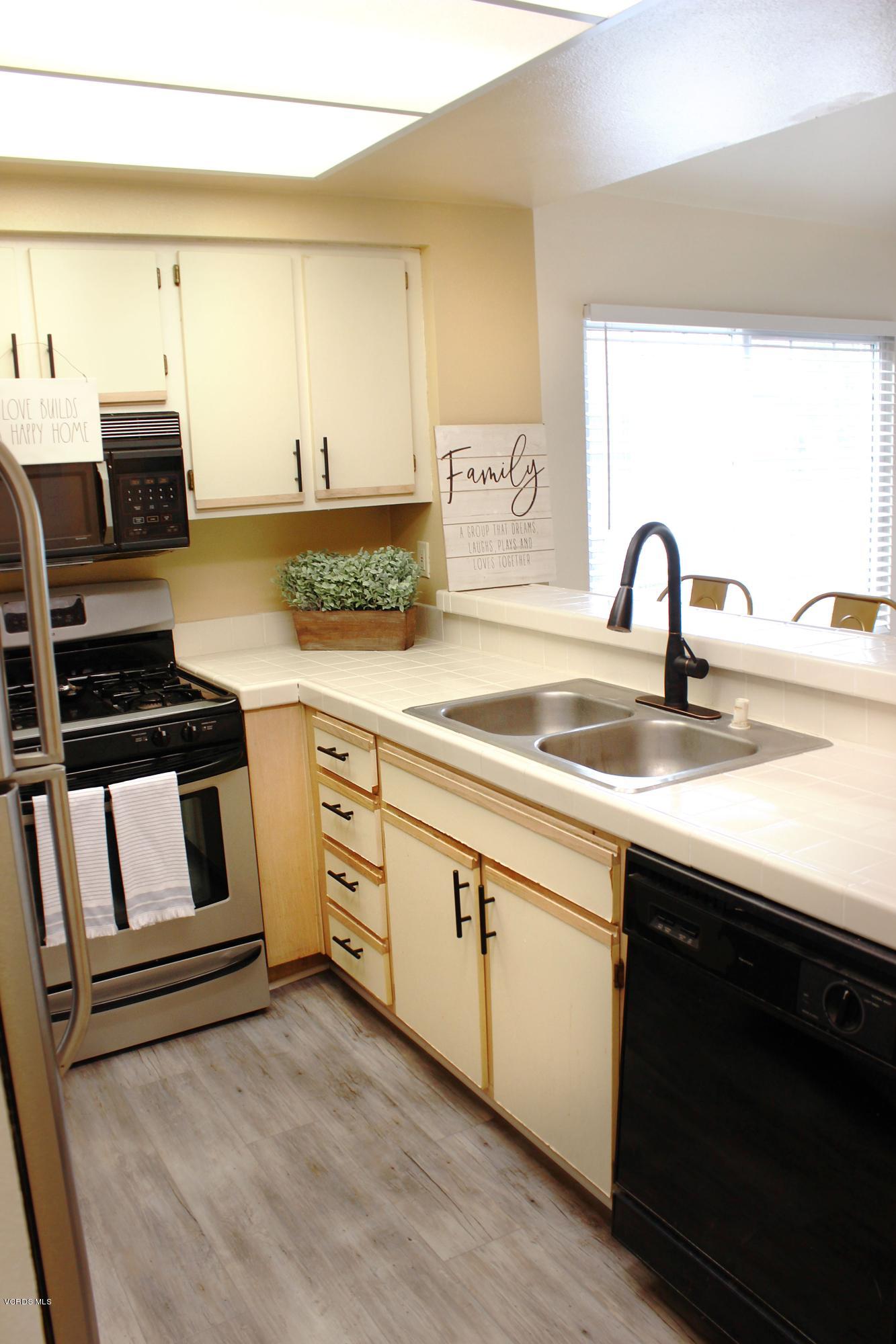 4240 Lost Hills Road, Unit 2907 Calabasas, CA 91301 - Photo 10 of 31 a kitchen with granite countertop a sink and a stove top oven