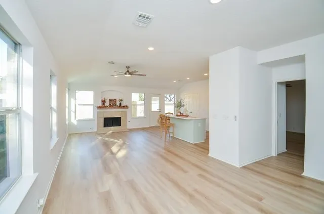 a view of kitchen and hall with wooden floor