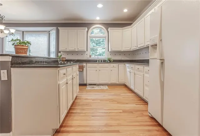 a kitchen with granite countertop a sink and cabinets