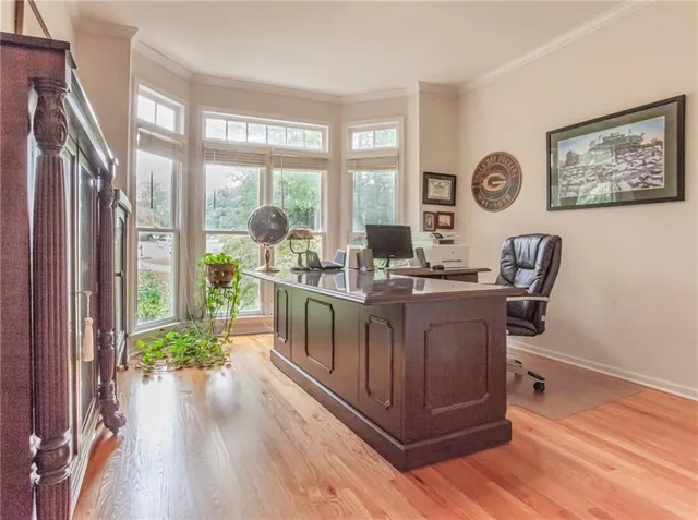 a living room with furniture large window and wooden floor