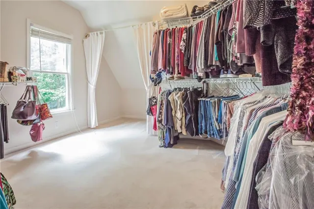 a view of walk in closet with clothes