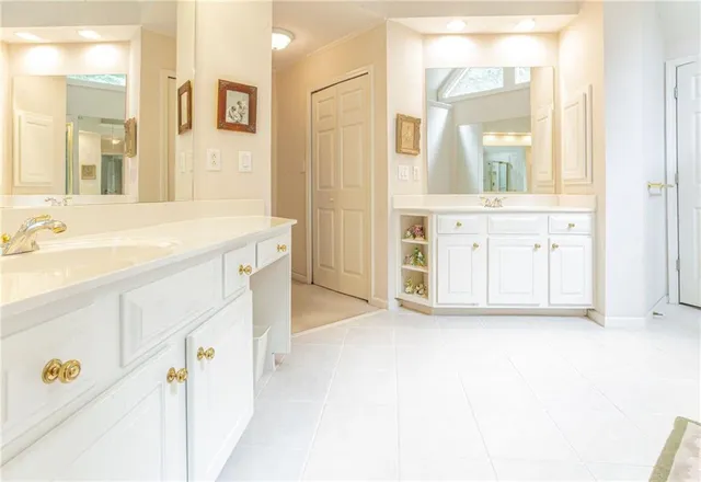 a spacious bathroom with a shower sink and a mirror
