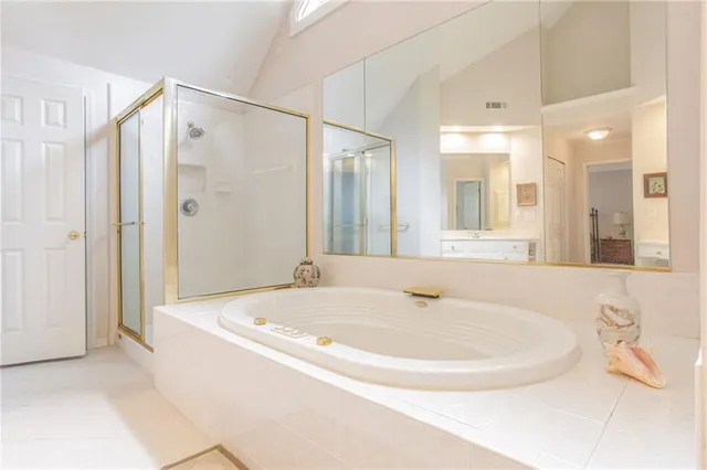 a bathroom with a bathtub and a shower
