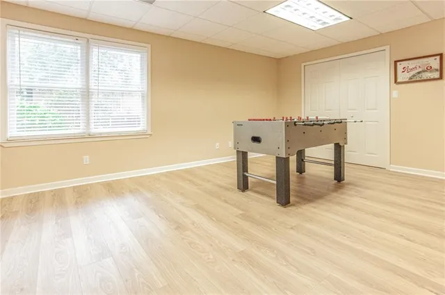 a view of a room with wooden floor and a window