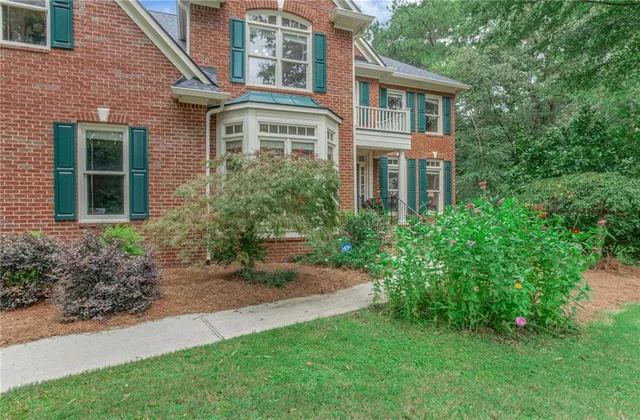 a front view of a house with a garden