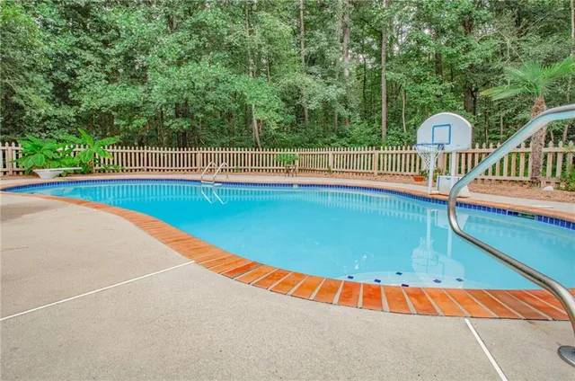 a view of a swimming pool with a lounge chair