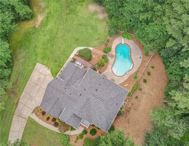 an aerial view of a house with a yard basket ball court and outdoor seating