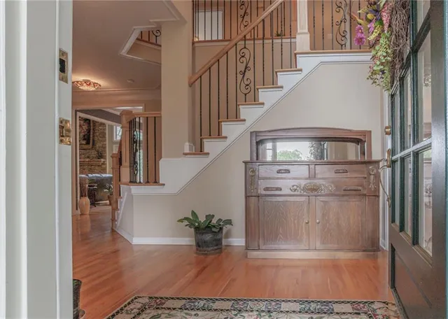 a view of entryway and hall with wooden floor