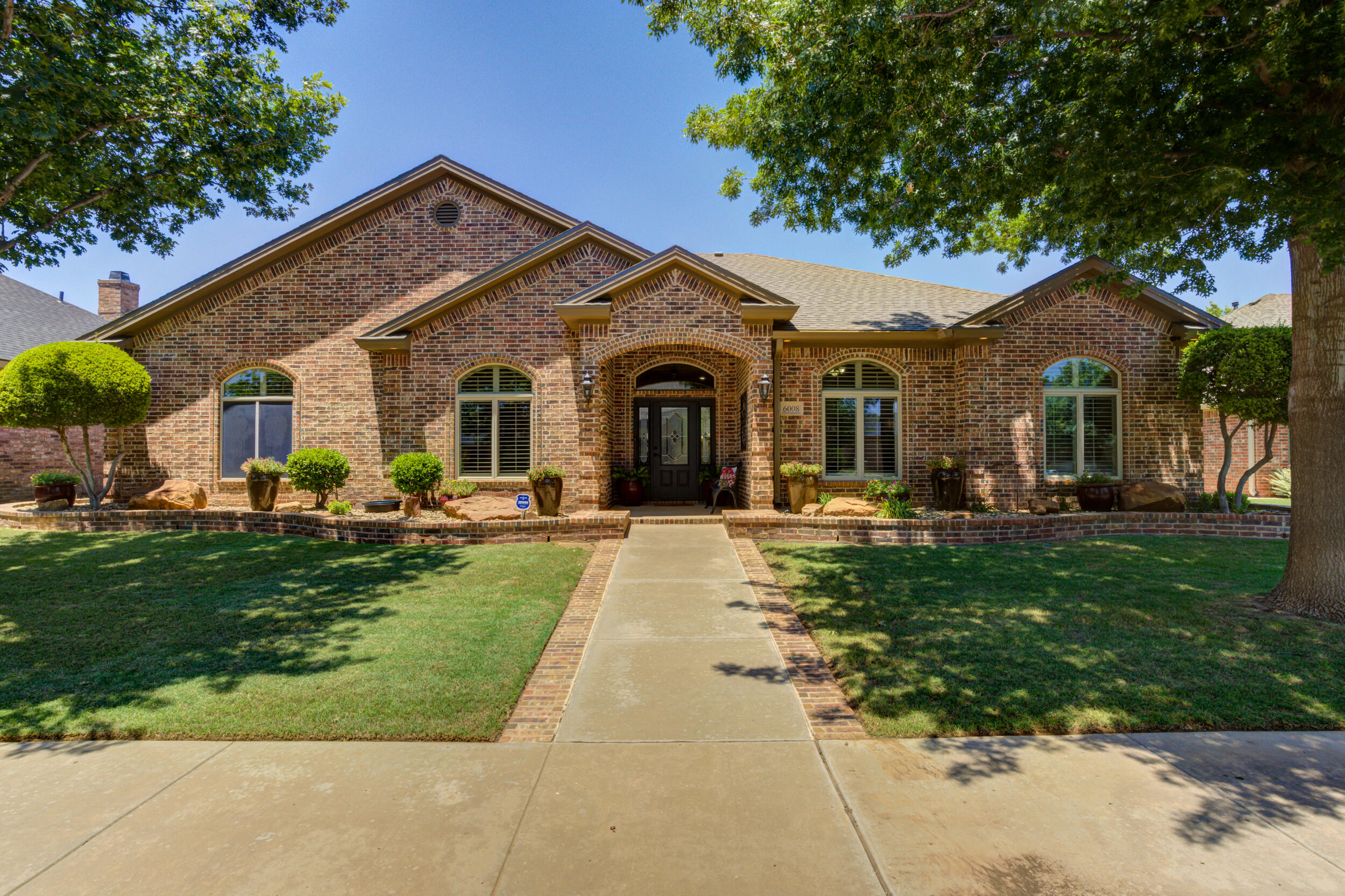 6008 89th Street Lubbock, TX 79424 - Photo 59 of 61 a front view of a house with garden