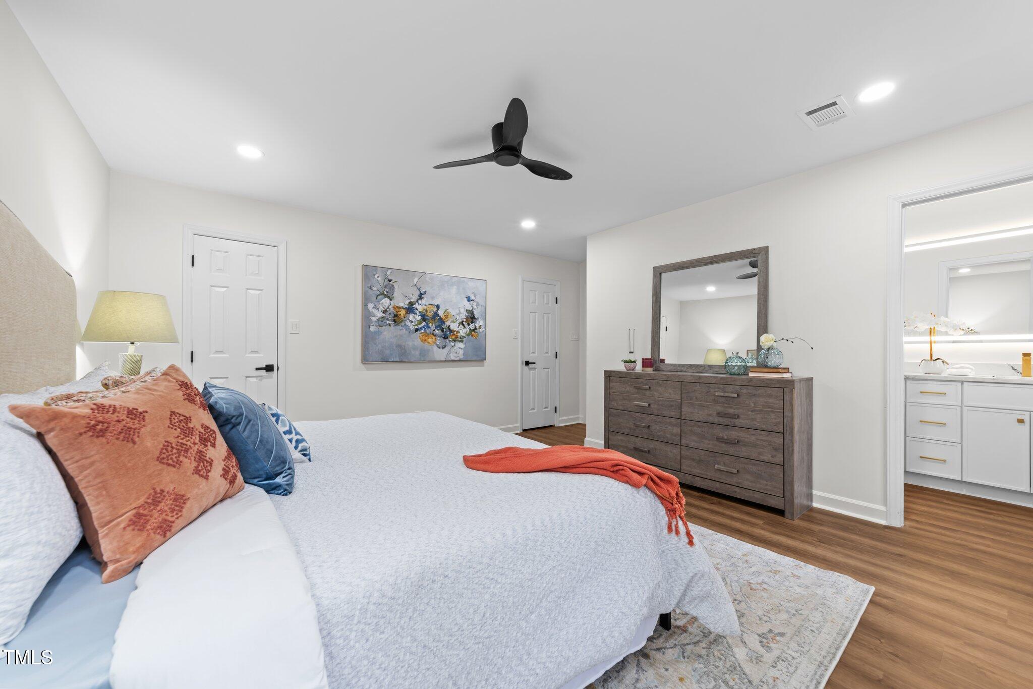 2001 Quail Ridge Road Raleigh, NC 27609 - Photo 23 of 40 a bedroom with a large bed and a dresser