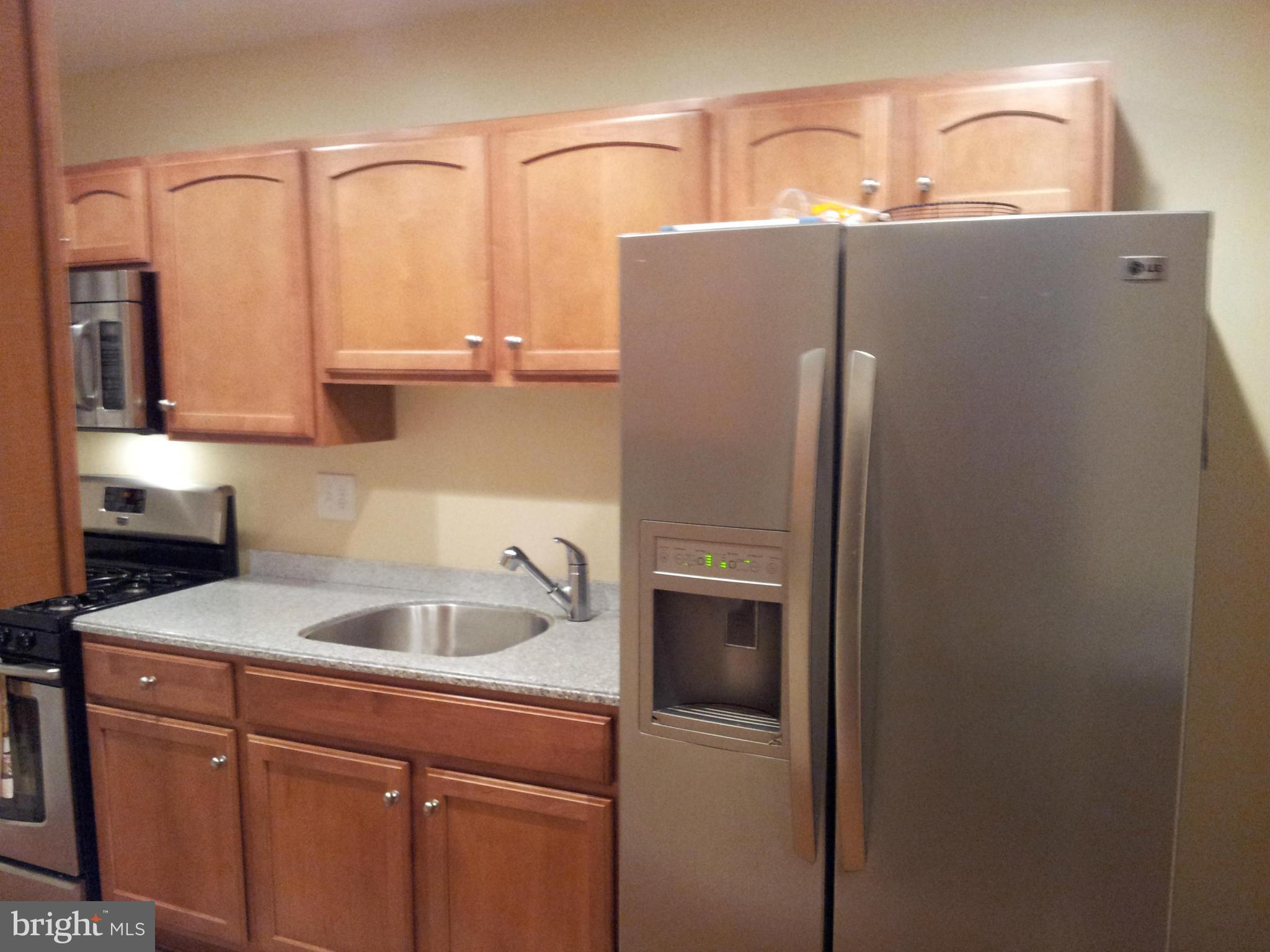 5815 Meridale Road Baltimore, MD 21228 - Photo 4 of 27 a kitchen with stainless steel appliances granite countertop a refrigerator and a sink
