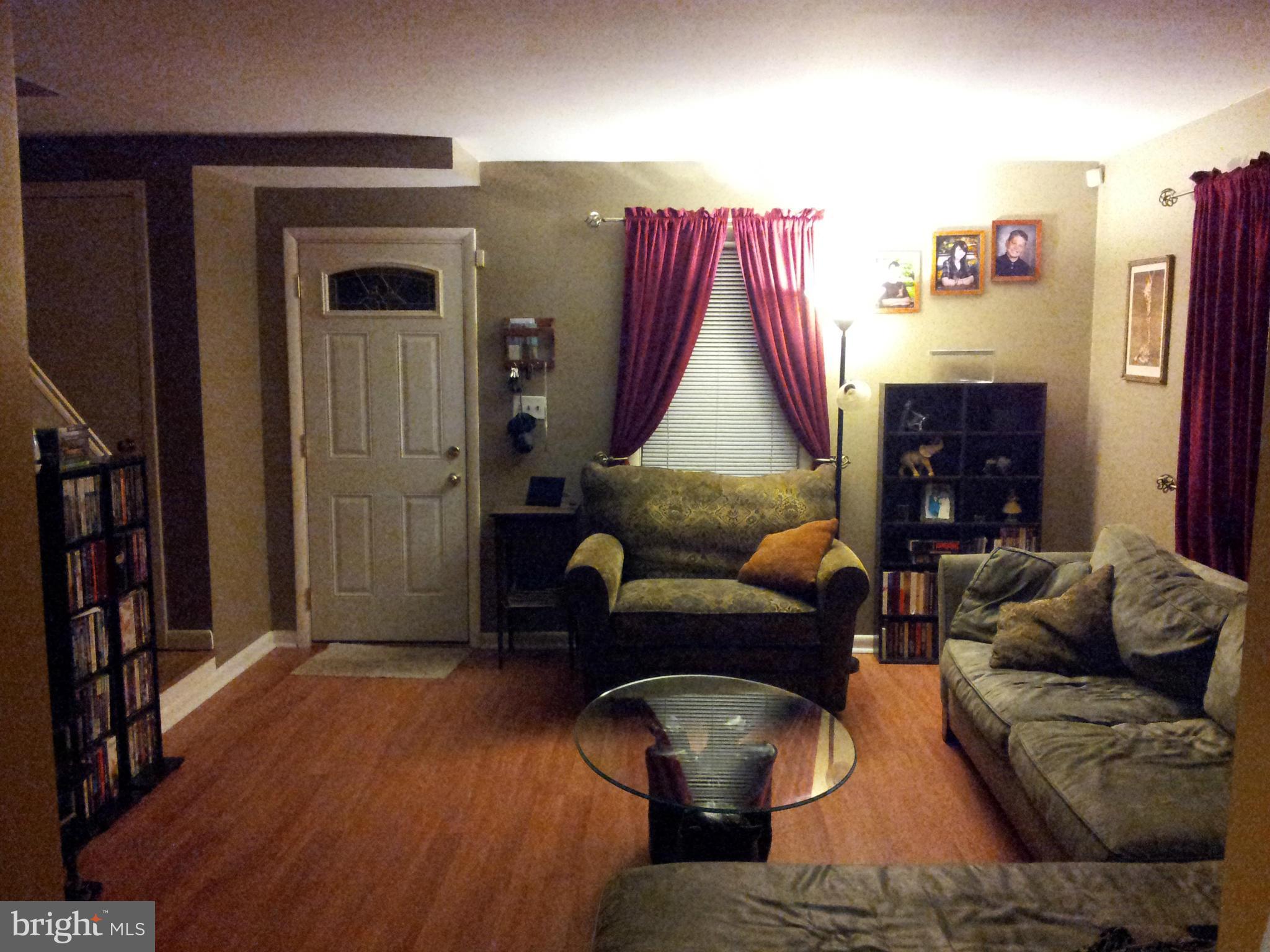 5815 Meridale Road Baltimore, MD 21228 - Photo 8 of 27 a living room with furniture and a fireplace