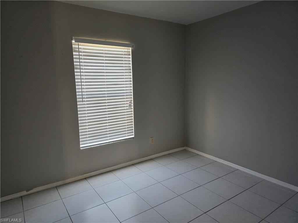 2660 Kings Lake Boulevard, Unit 7103 Naples, FL 34112 - Photo 10 of 22 an empty room with a window
