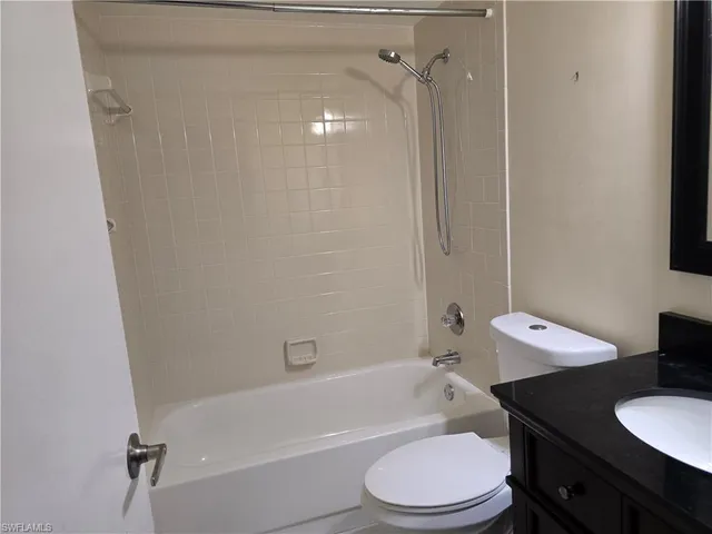 a bathroom with a sink toilet vanity and shower