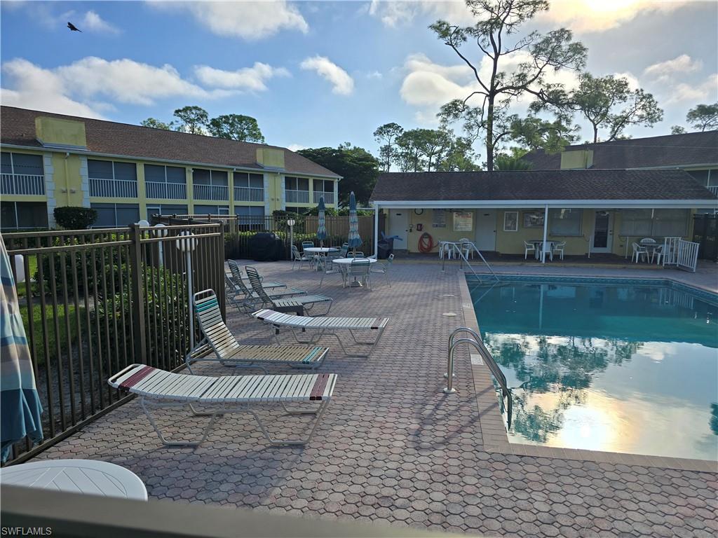 2660 Kings Lake Boulevard, Unit 7103 Naples, FL 34112 - Photo 17 of 22 a view of a house with backyard