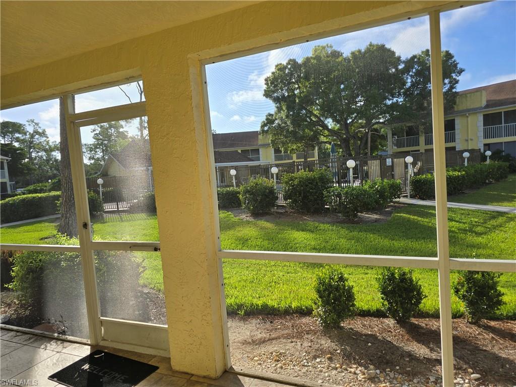 2660 Kings Lake Boulevard, Unit 7103 Naples, FL 34112 - Photo 19 of 22 a view of a house with a big yard potted plants