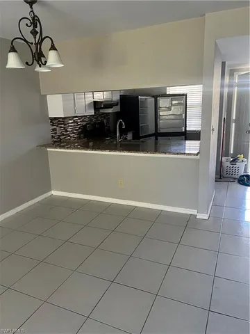 an empty room with a ceiling fan and a window