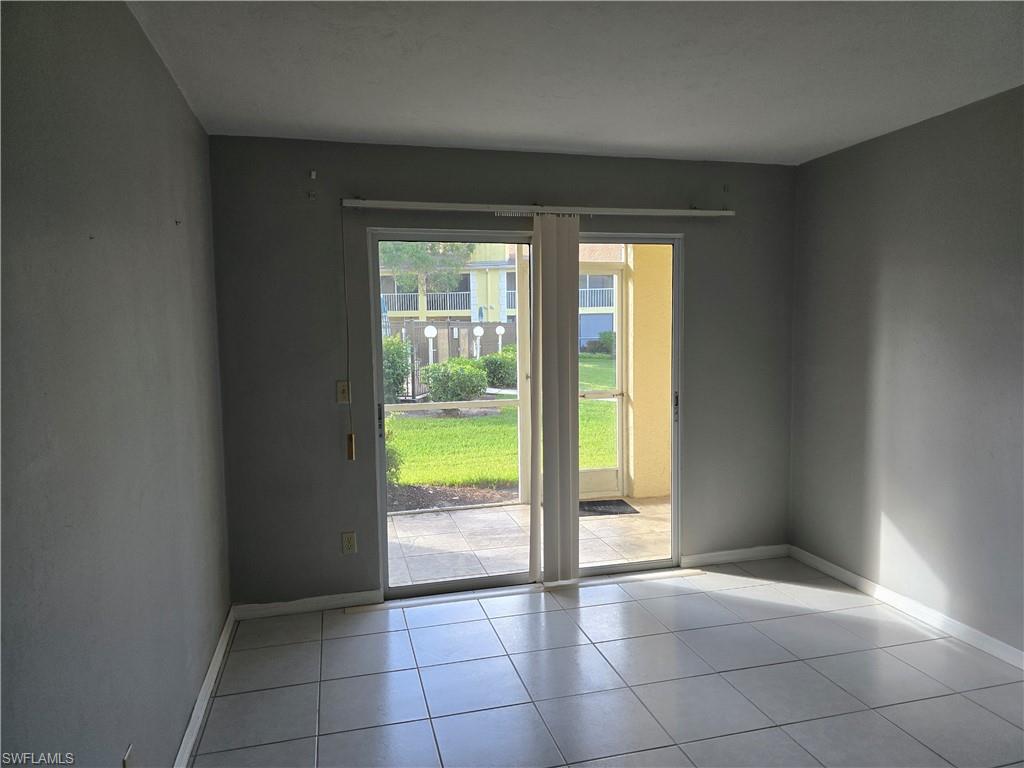 2660 Kings Lake Boulevard, Unit 7103 Naples, FL 34112 - Photo 5 of 22 a view of an empty room and window