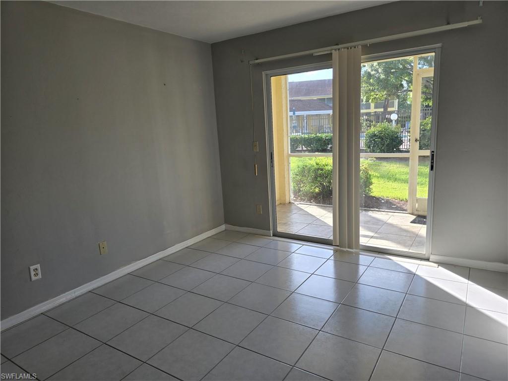 2660 Kings Lake Boulevard, Unit 7103 Naples, FL 34112 - Photo 7 of 22 a view of an empty room and window