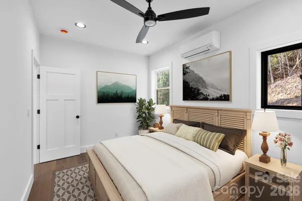 a bedroom with a bed and a flat screen tv