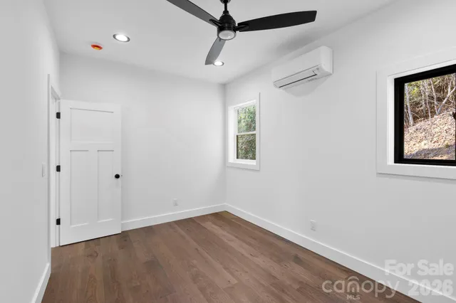 a view of a room with wooden floor and window