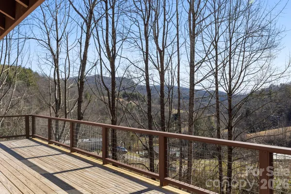 a view of balcony with wooden floor and fence