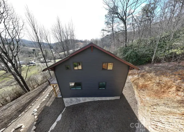 a view of a house with a large tree