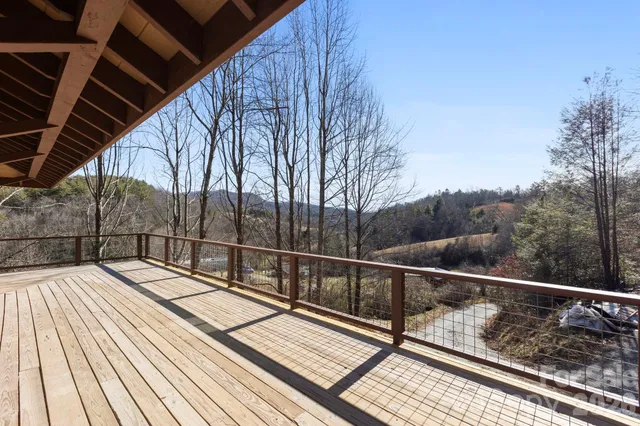a view of balcony with wooden floor and fence
