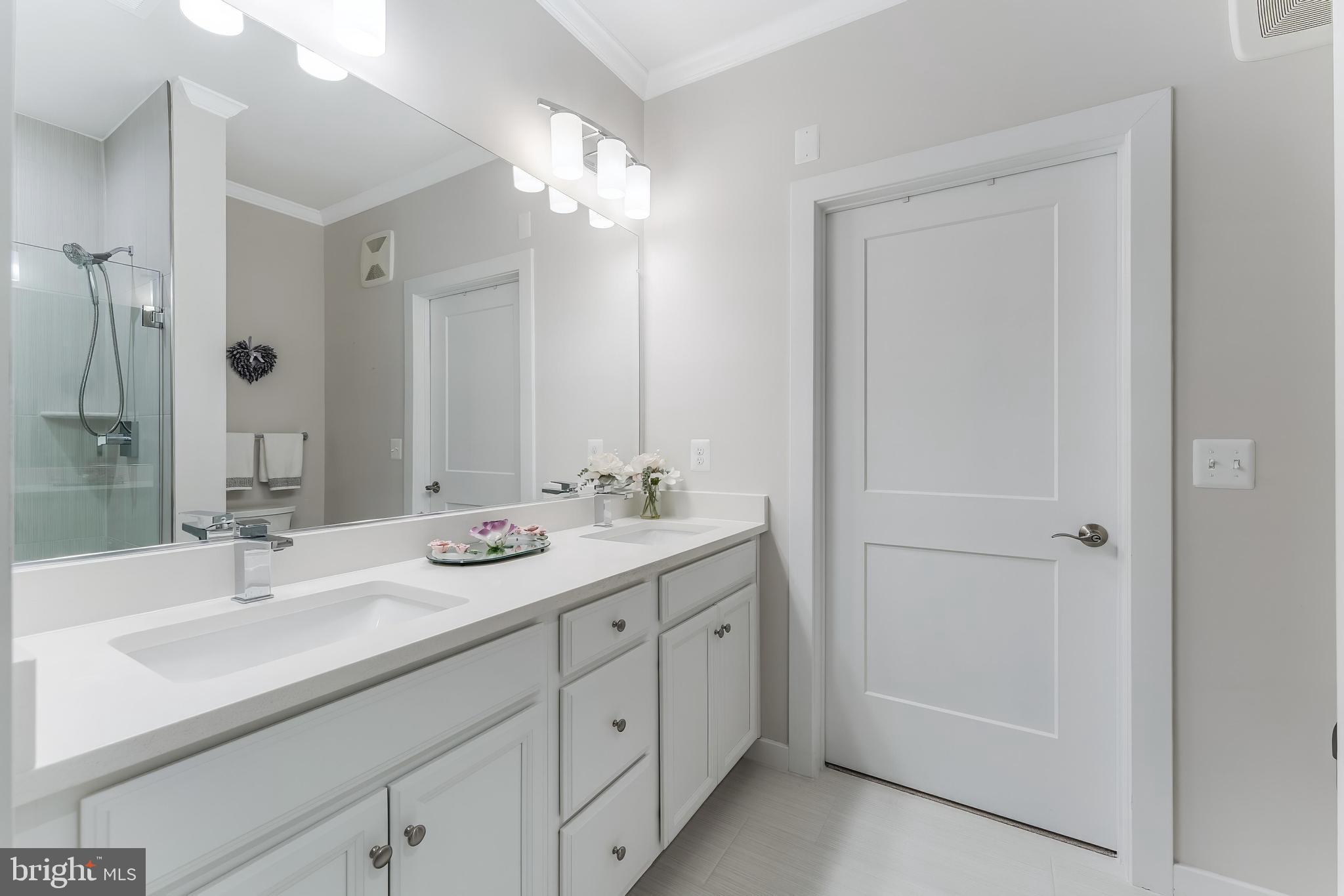 1675 Bandit Loop, Unit 105B Reston, VA 20190 - Photo 16 of 27 a bathroom with double sink and a mirror