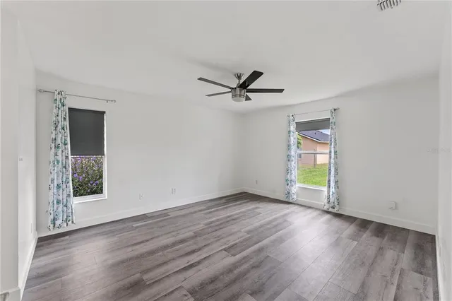 a view of a livingroom with a hardwood floor and a ceiling fan