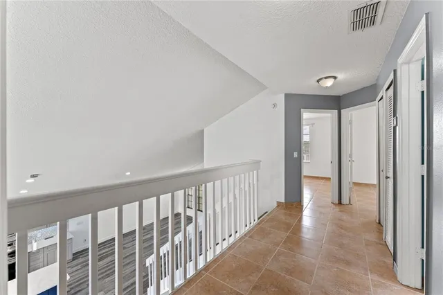 a view of a hallway with wooden floor and entryway